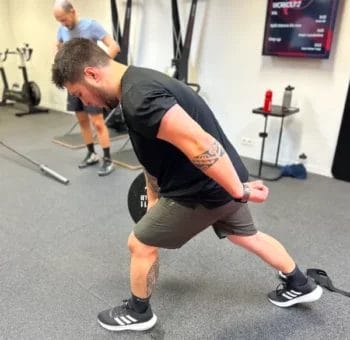 Athlete performing lunge exercise during functional training at SHARP GYM