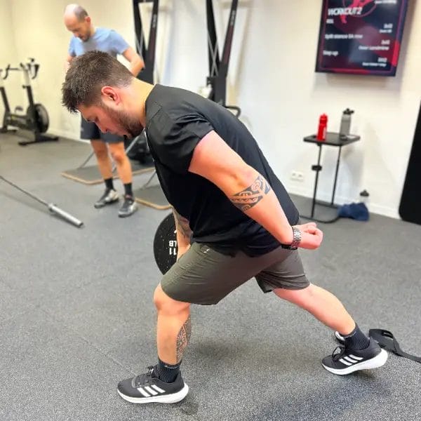 Athlete performing lunge exercise during functional training at SHARP GYM