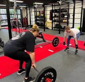 Group barbell workout session at SHARP GYM