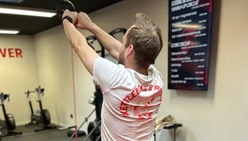 Man doing resistance band workout at SHARP GYM